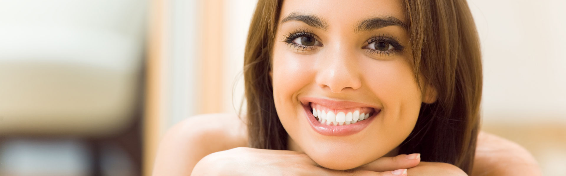 Smiling woman after having dental bridges treatment