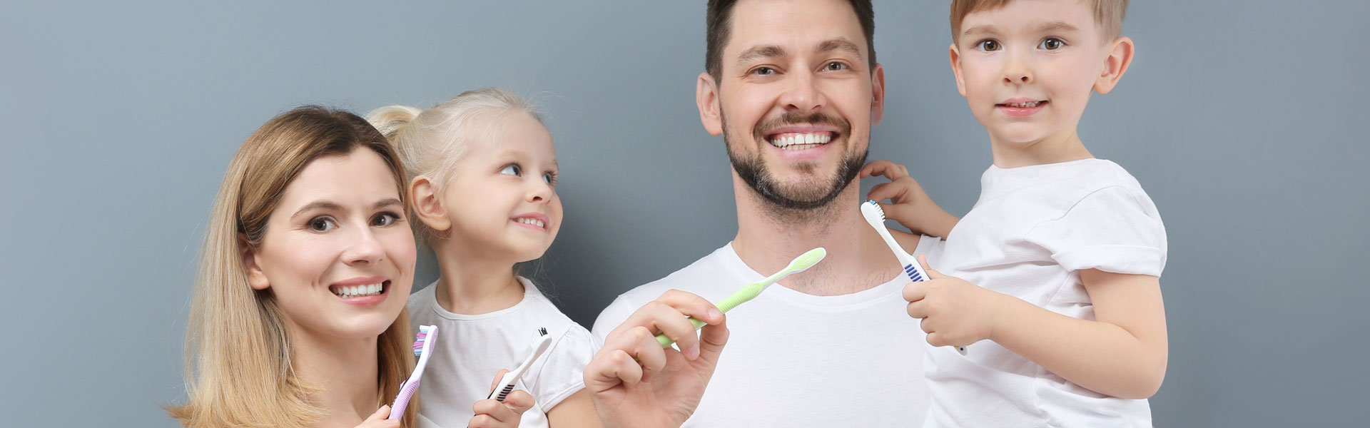 Young family brushing teeth